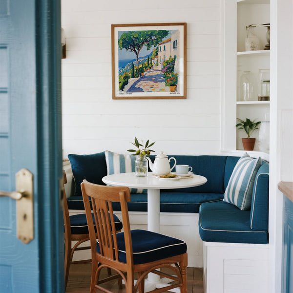Nook with blue cushioned bench and framed Henri Matisse Artwork of Ravello. 