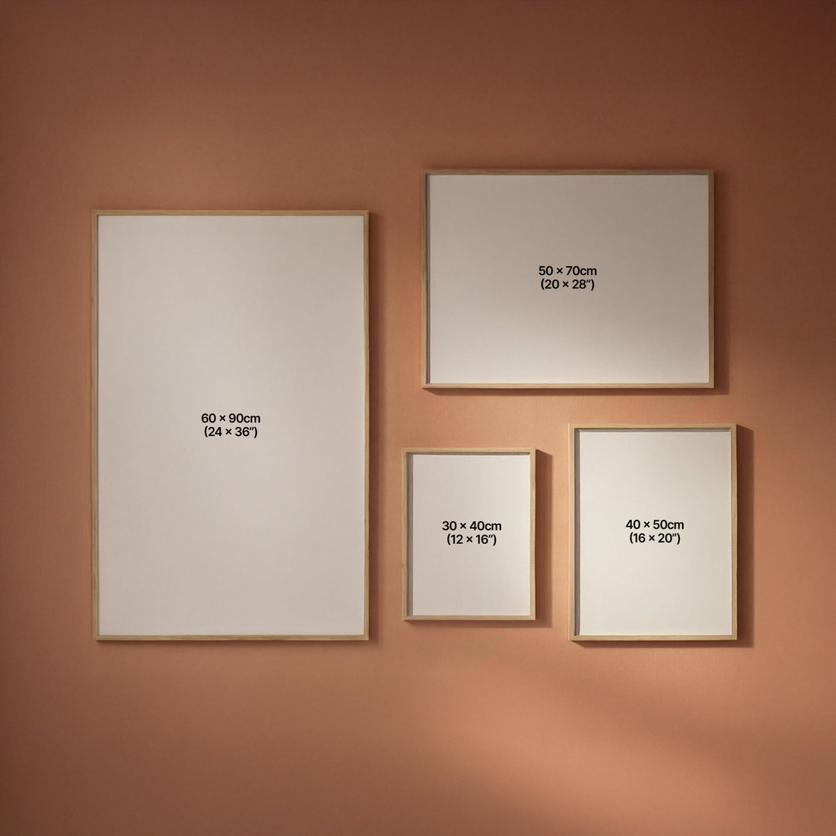Four framed artworks of different sizes on a peach wall