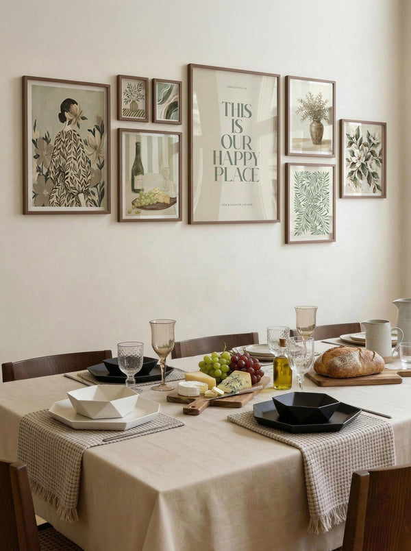 Dining room with a table set for a meal, framed pictures on the wall, and 'This is our happy place' quote.