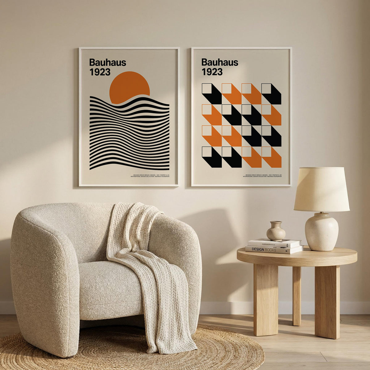 Gallery wall with Bauhaus wall art featuring geometric shapes in orange and black above a beige armchair and wooden side table