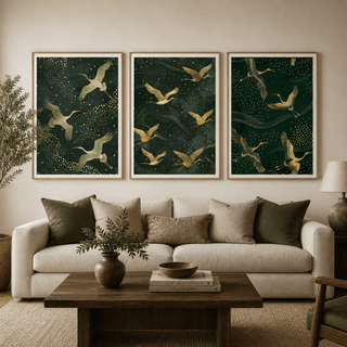 Set of 3 Art Prints of golden cranes flying against a dark green starry background above a beige sofa with green and beige cushions
