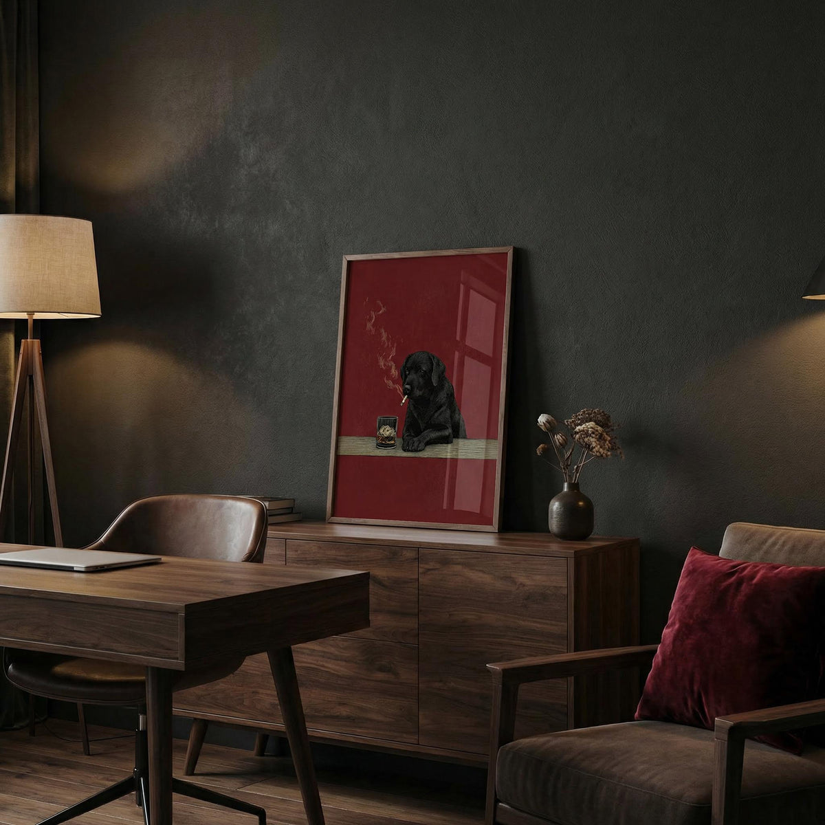 Dark-themed room with a desk, chair, and framed picture on a wall.