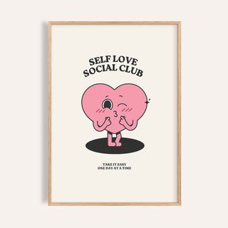 Framed inspirational quotes wall decor with a pink winking heart character and black text on cream background