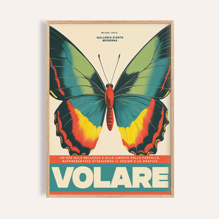 Framed close-up of large butterfly wall art with green yellow and red on cream background
