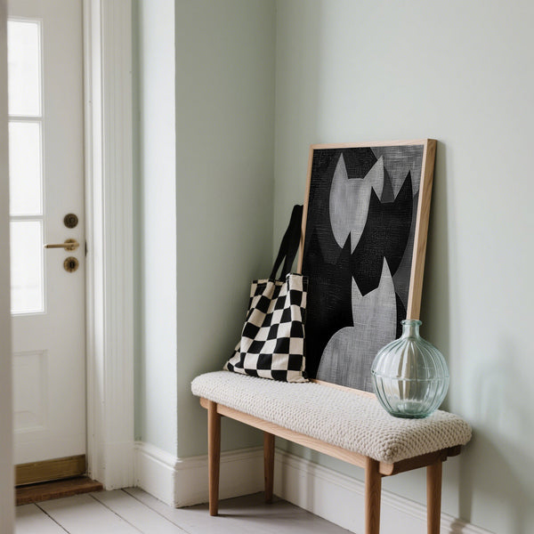 Black and white cat art leaning on bench in hallway