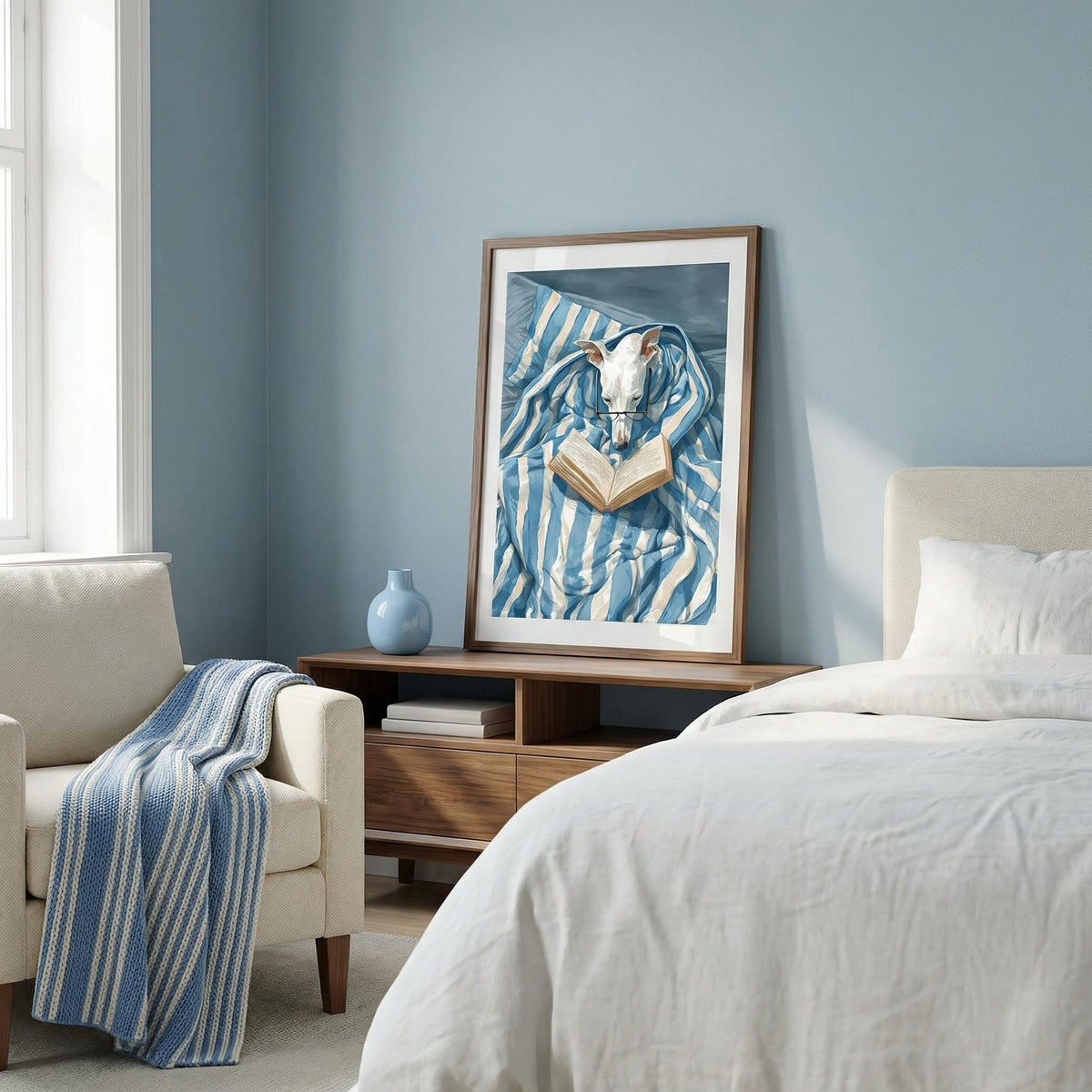Modern bedroom with a bed, armchair, and framed artwork on the wall.