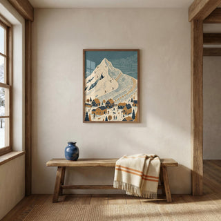 Nestled corner of a room with a wooden bench, blue vase, and framed mountain ski slope landscape wall art on a beige wall.