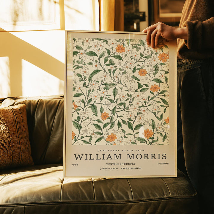 Framed Vintage Prints Flowers artwork with orange and white flowers against a cream background held by a person