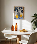 Abstract lemon art showcasing bright citrus and a navy and cream-striped vase.