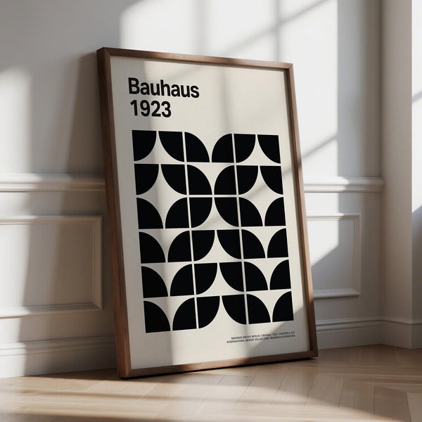 Mid century art prints with black geometric shapes on a neutral background.