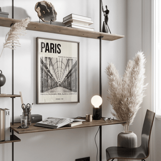 Framed print on office wall featuring long tiled corridor and hanging lanterns