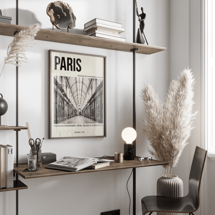 Parisian Passage Art Print framed on wall above desk with lamp and pampas grass beside