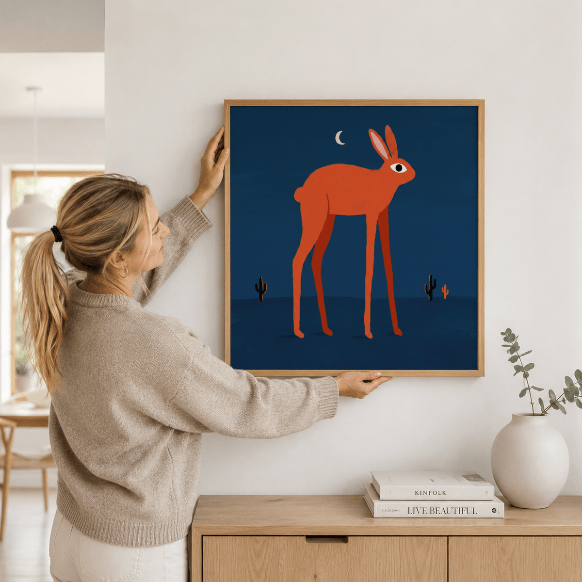 Graphic rabbit wall art print featuring oversized eye and sparse desert cacti
