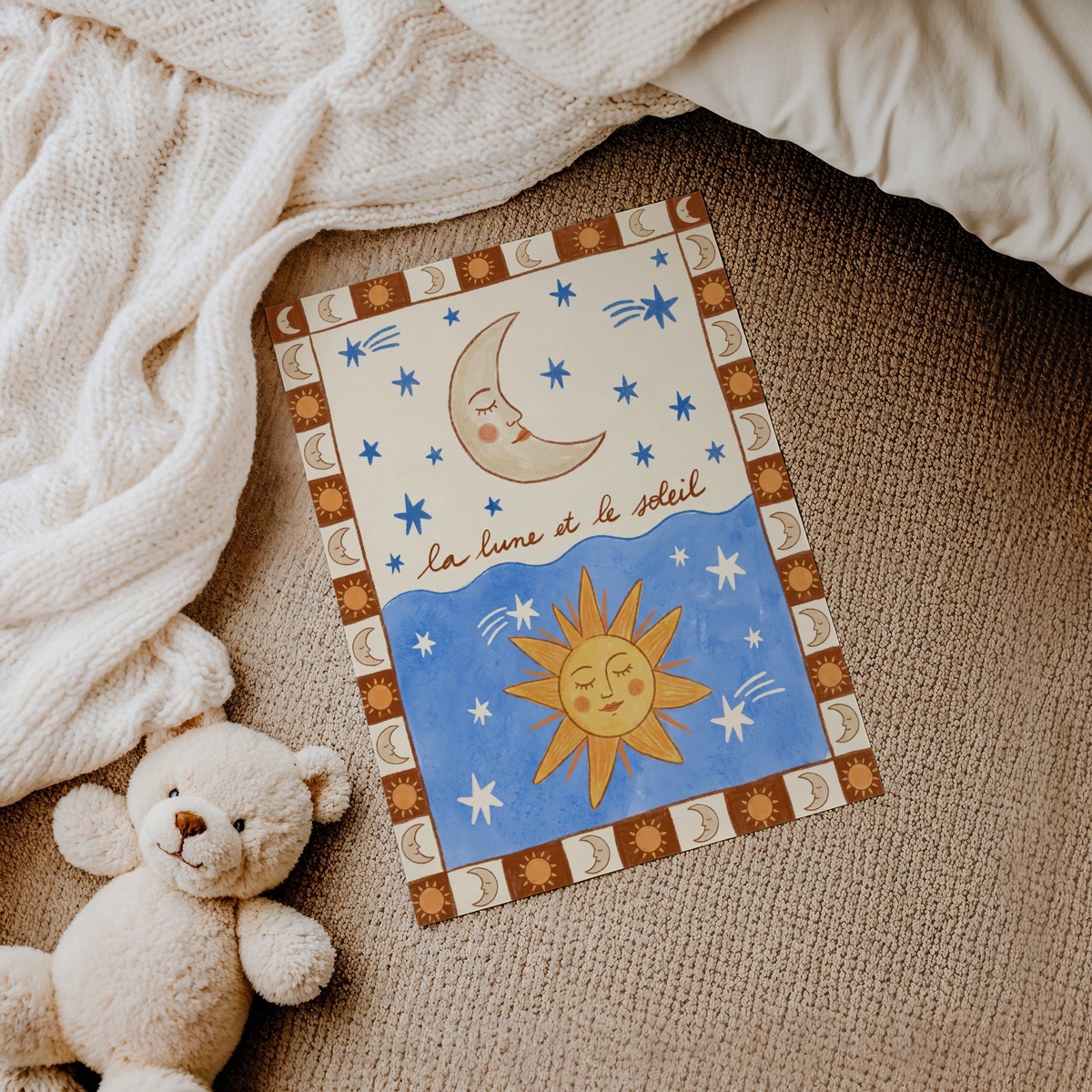 Framed Moon and Sun Print leaning on a shelf with other sky themed artwork