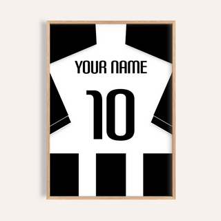 Framed print close-up of football shirt poster in black and white stripes with black sleeves on a pale background