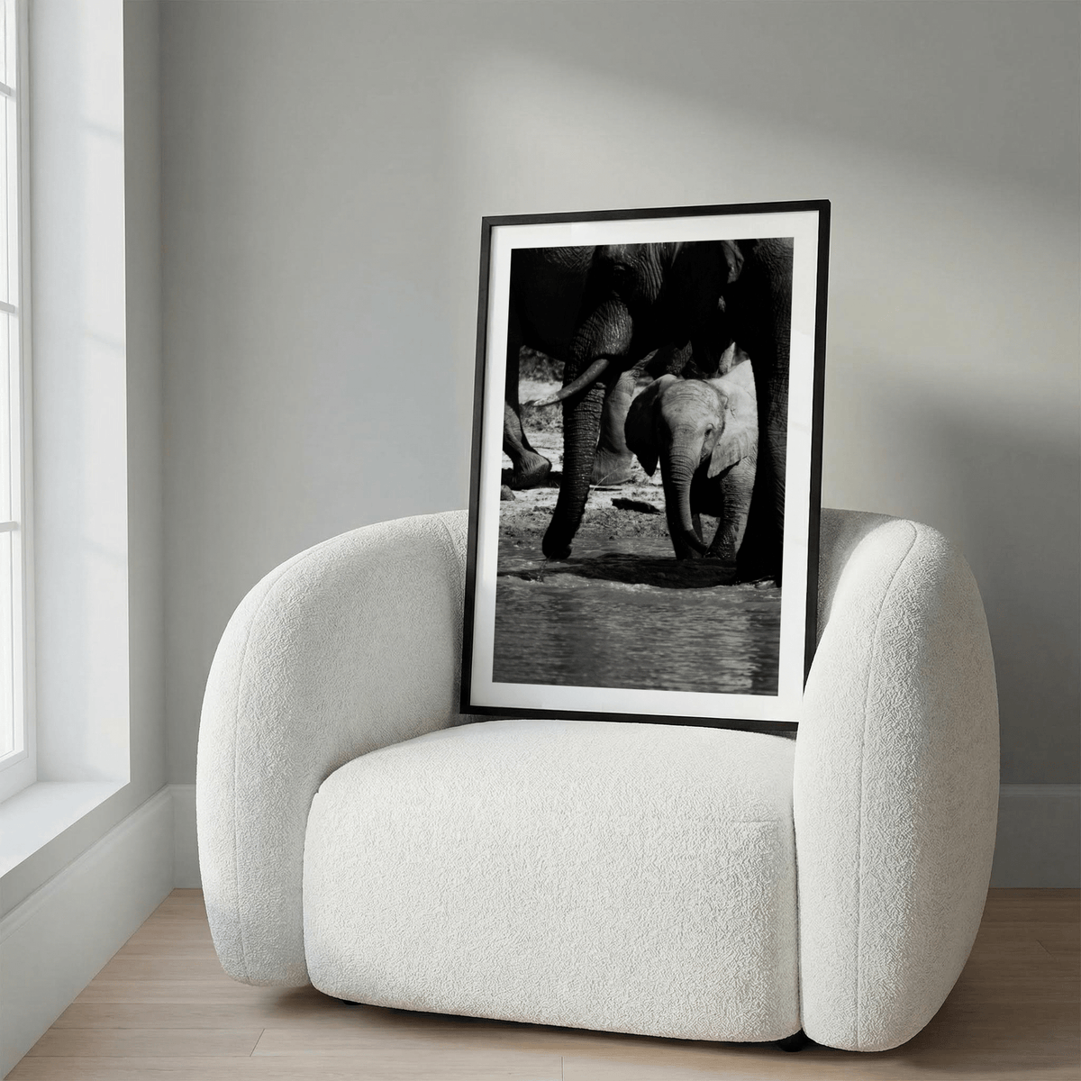 Close-up wildlife wall art print showing baby elephant by adult legs