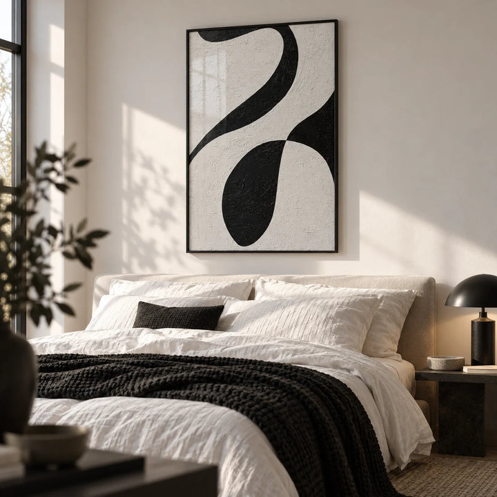 Abstract Black and White Art, framed on the wall of a calm monochrome bedroom with a soft white wall