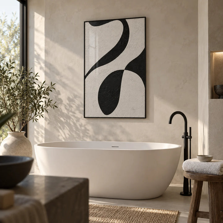 Abstract Black and White Art, framed on the wall of a modern spa bathroom with off-white microcement walls