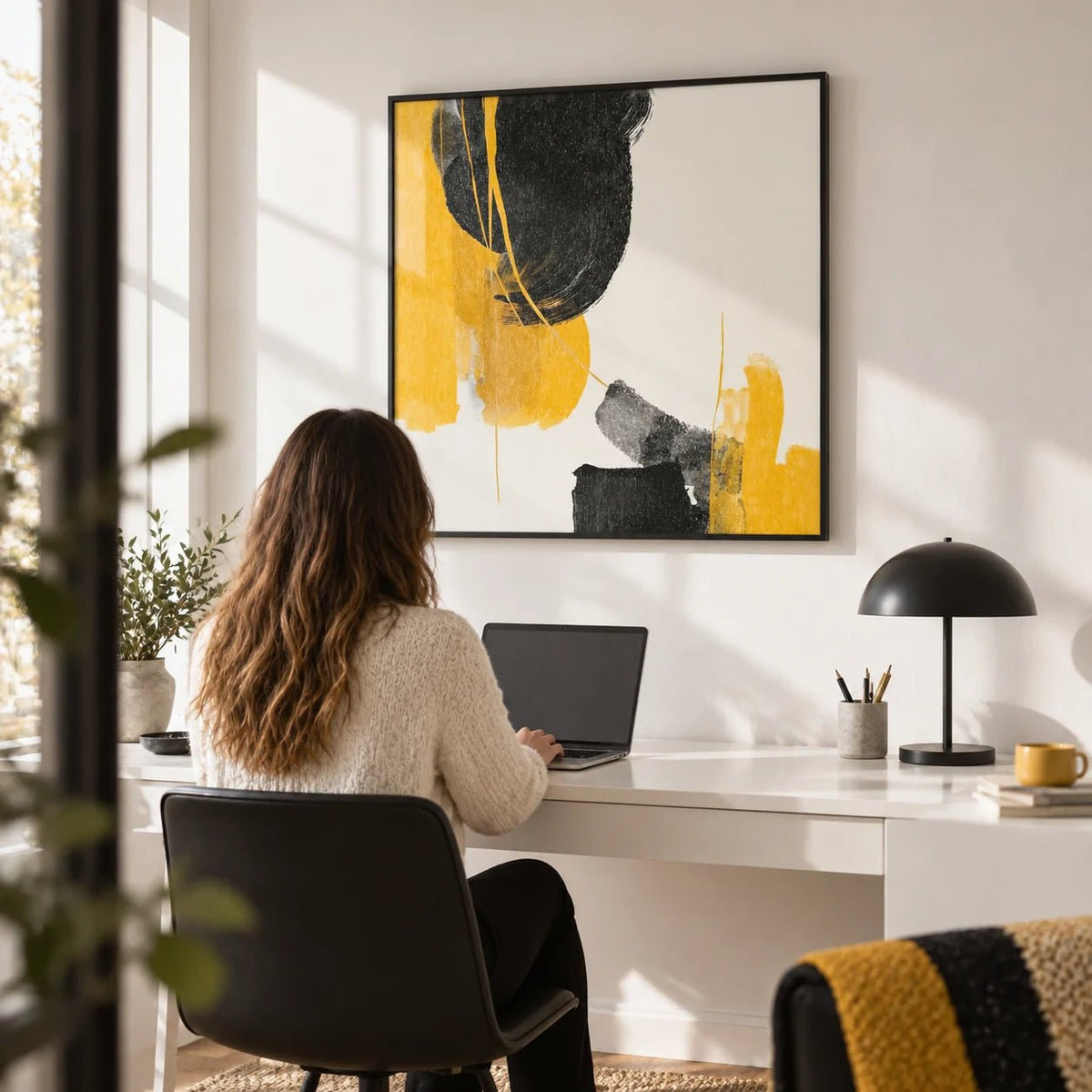 Abstract Black and Yellow Art, framed on the wall of a crisp home office with a white wall