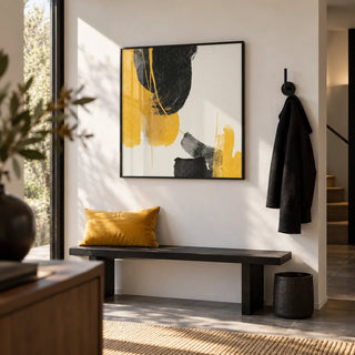 Abstract Black and Yellow Art, framed on the wall of a modern hallway with a white wall