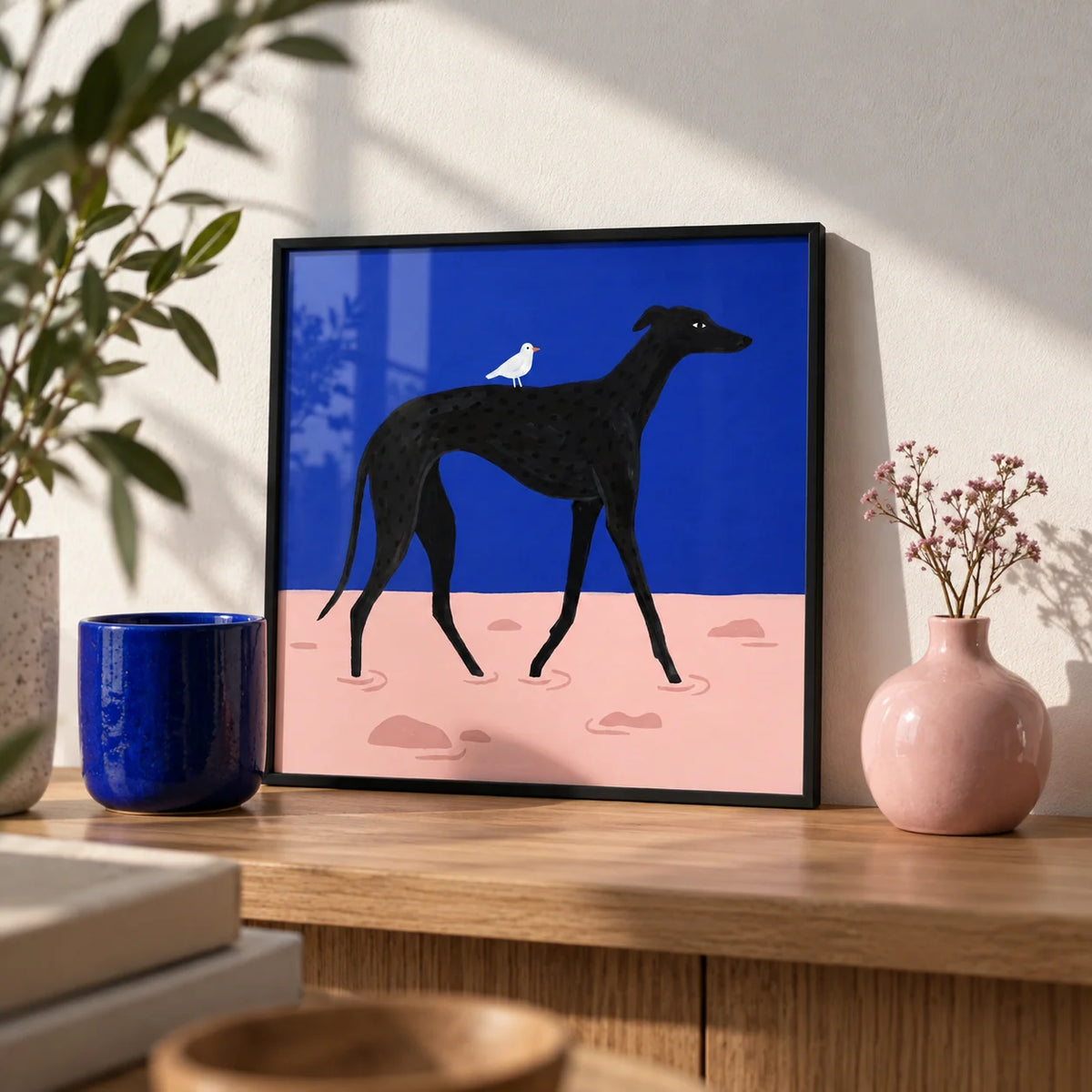 Abstract Black Dog Poster, a small A4 framed print leaning on an oak shelf in a living room