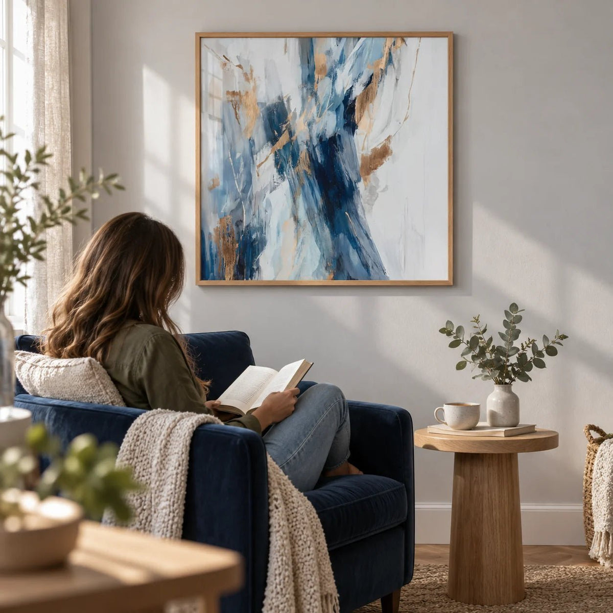 Abstract Blue Wall Art, framed on the wall of a calm reading corner with a pale grey wall in a living room