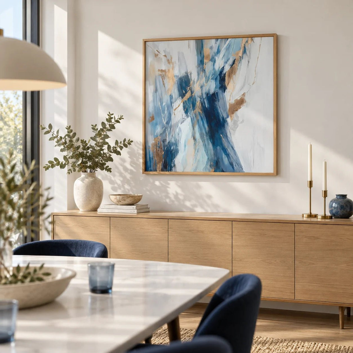 Abstract Blue Wall Art, framed on the wall of a light dining room with a soft white wall
