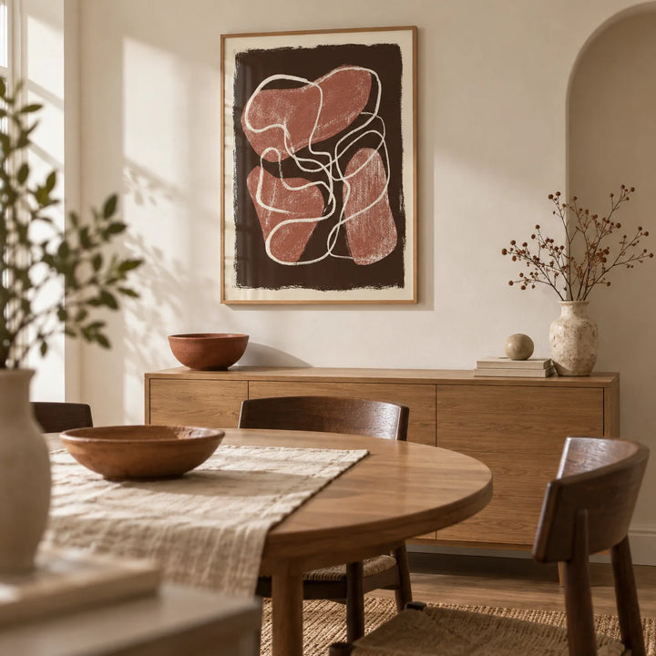 Abstract Earth Tone Print, framed on the wall of a modern dining room in a renovated UK terrace with warm white walls and a shallow arched alcove