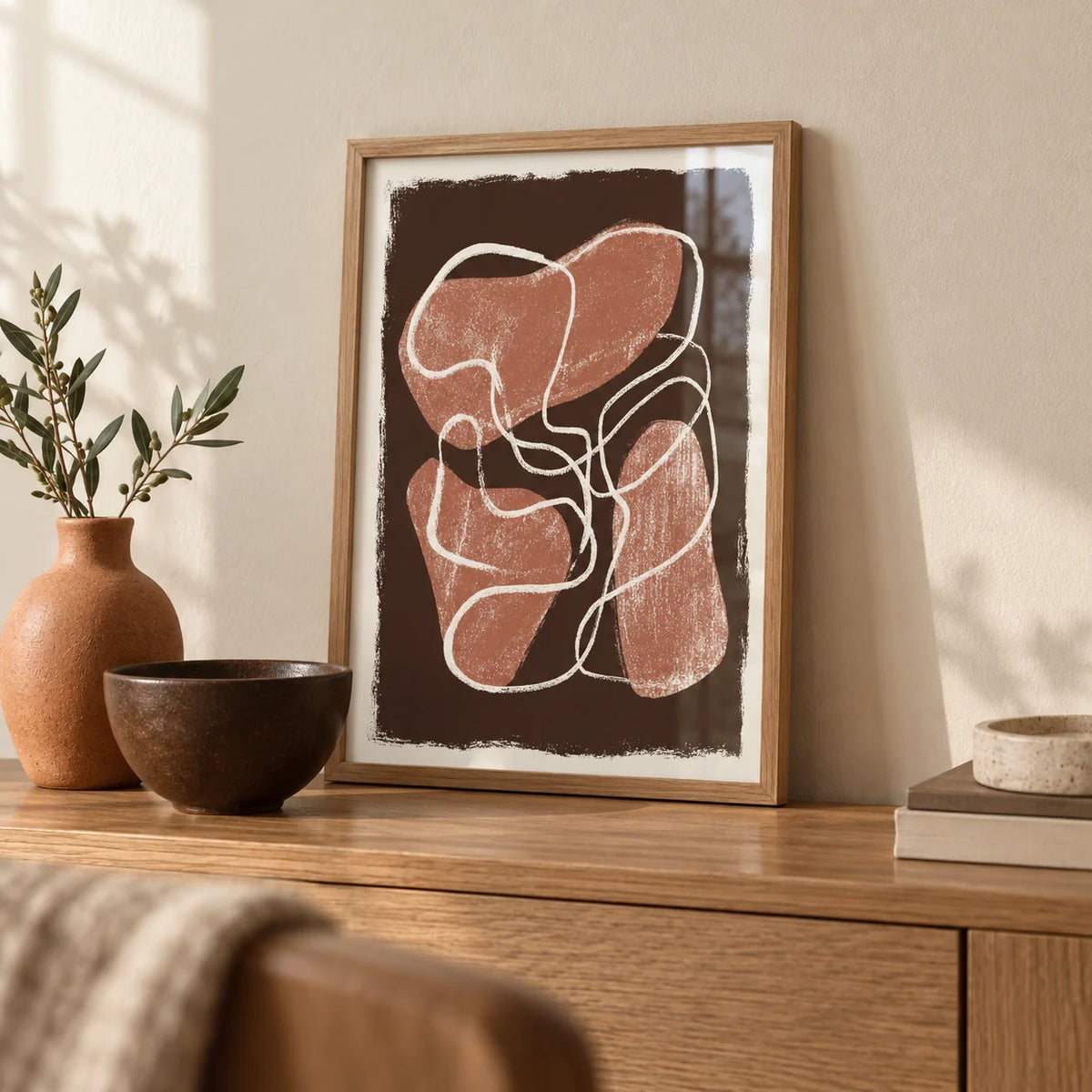 Abstract Earth Tone Print, a small A4 framed print leaning on an oak sideboard in a living room