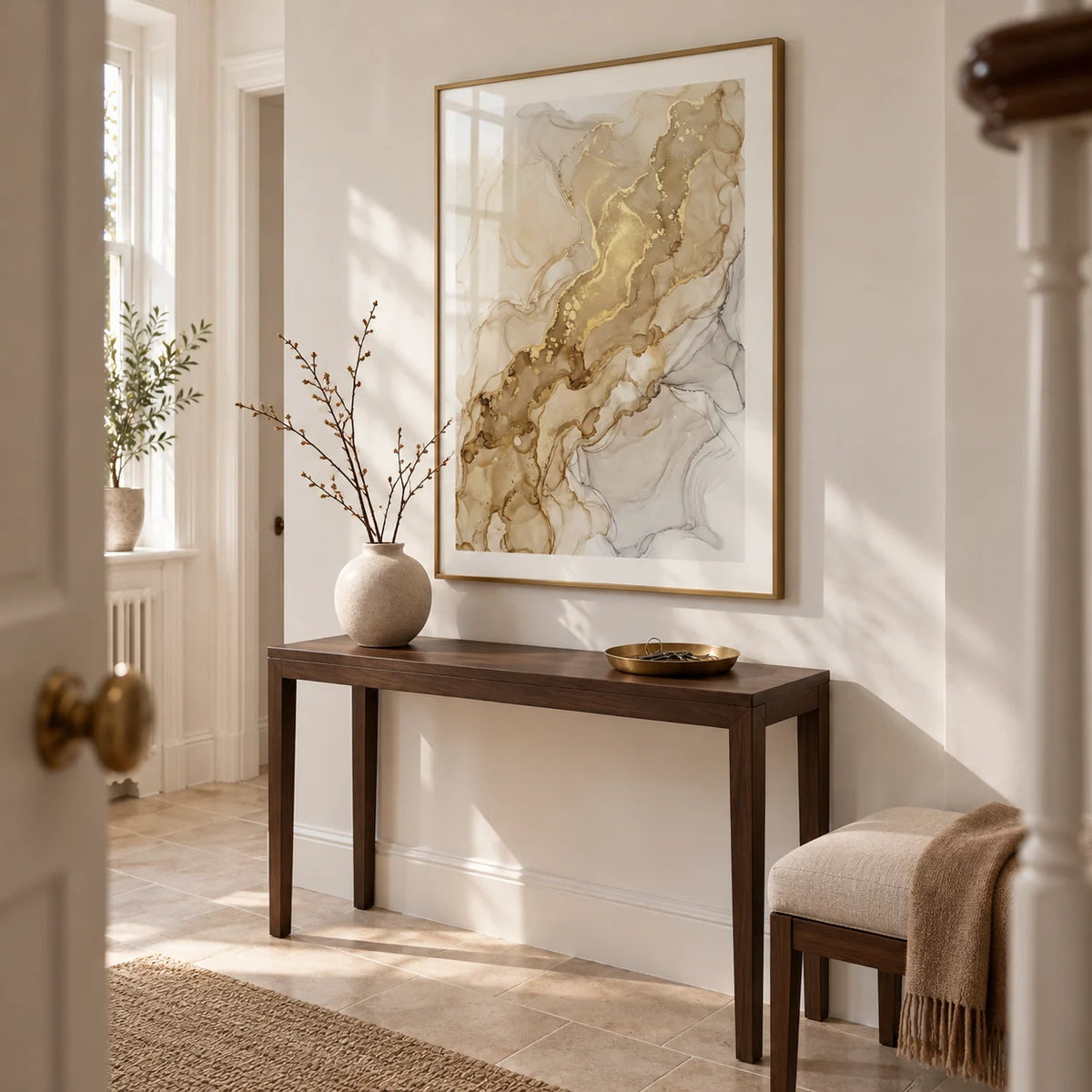 Abstract Gold Art Print, framed on the wall of a bright entrance hallway in a UK flat with chalk-white walls and pale stone flooring