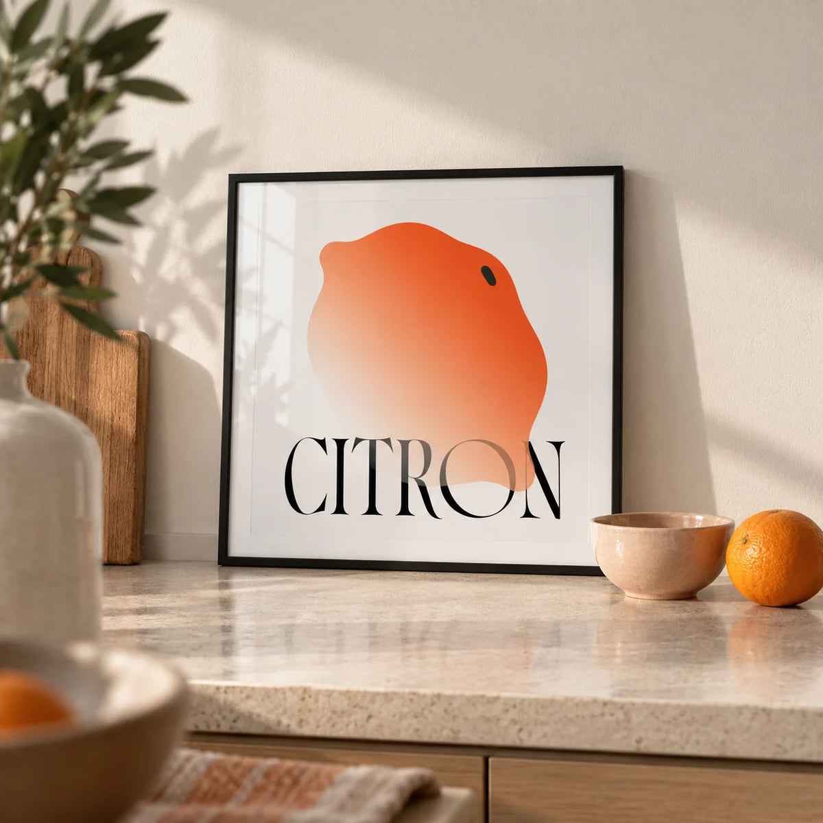 Abstract Lemon Art Print, a small A4 framed print leaning on a pale stone kitchen worktop