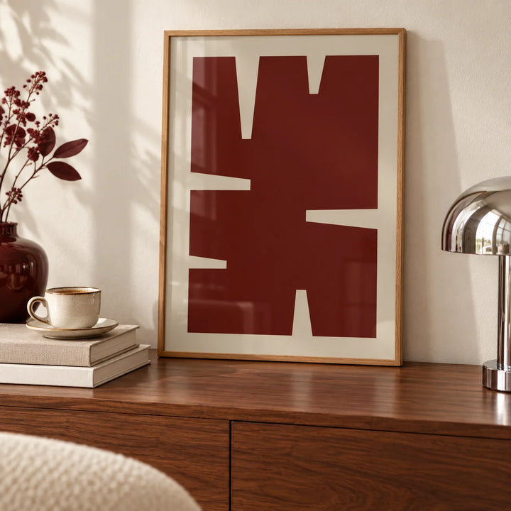 Dark Red Wall Art, a small A4 framed print leaning on a walnut sideboard in a living room
