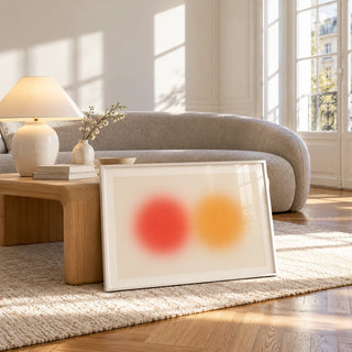 Abstract Sun Wall Art, framed and leaning against a coffee table in a bright living room