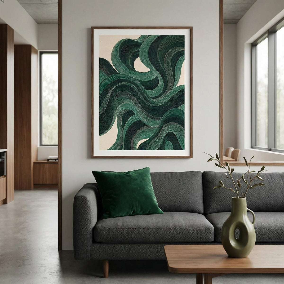 Living room with a gray sofa, green pillow, and abstract art on the wall.