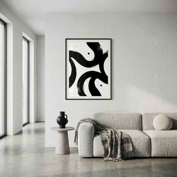 Modern living room with abstract black and white artwork on the wall, gray sofa, and small table.