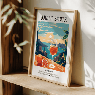 Graphic Amalfi Spritz Wall Art featuring orange slice, whole citrus, and illustrated seaside backdrop