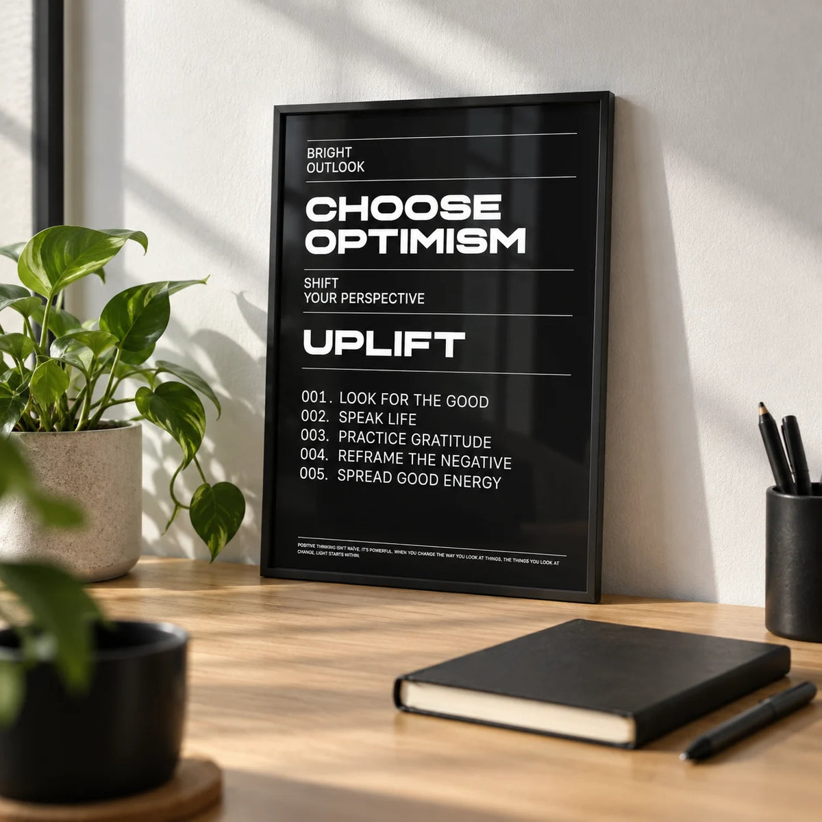 Affirmation Print, a small A4 framed print leaning on a light oak desk