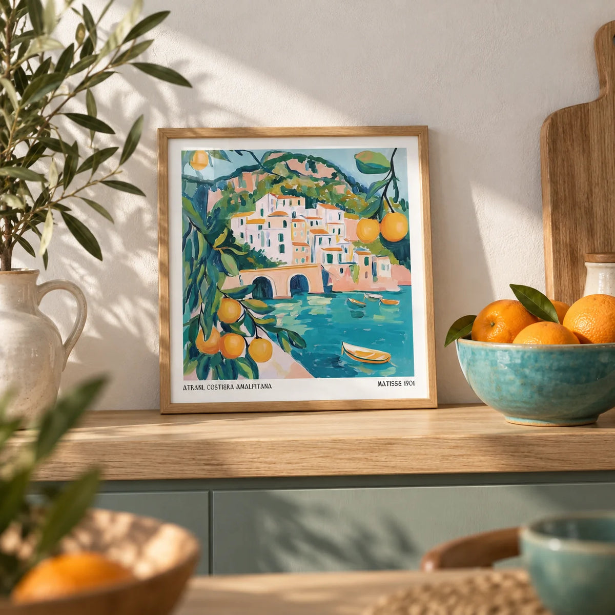 Amalfi Coast Painting, a small A4 framed print leaning on a pale oak kitchen shelf