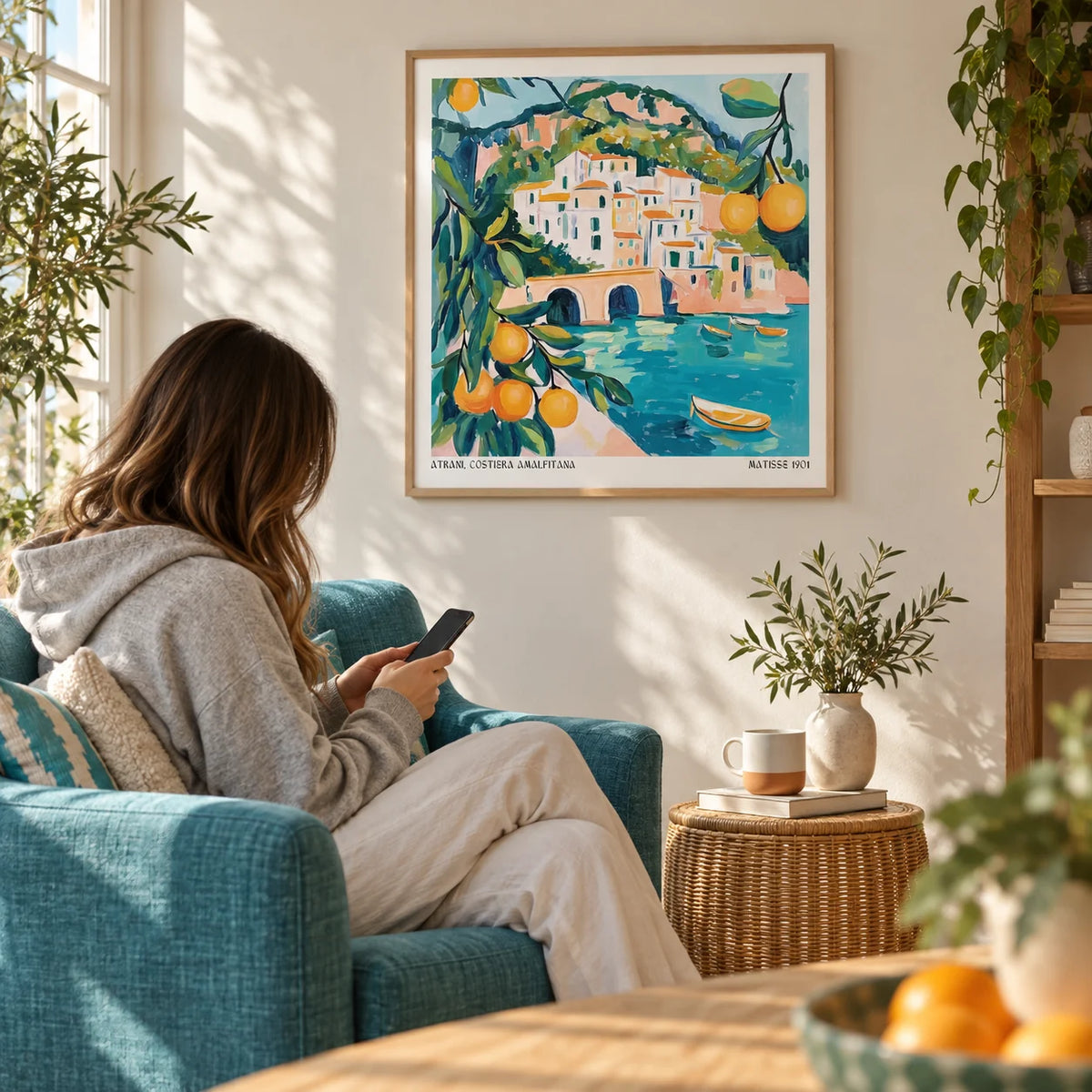 Amalfi Coast Painting, framed on the wall of a sunny reading corner with a warm white wall in a living room