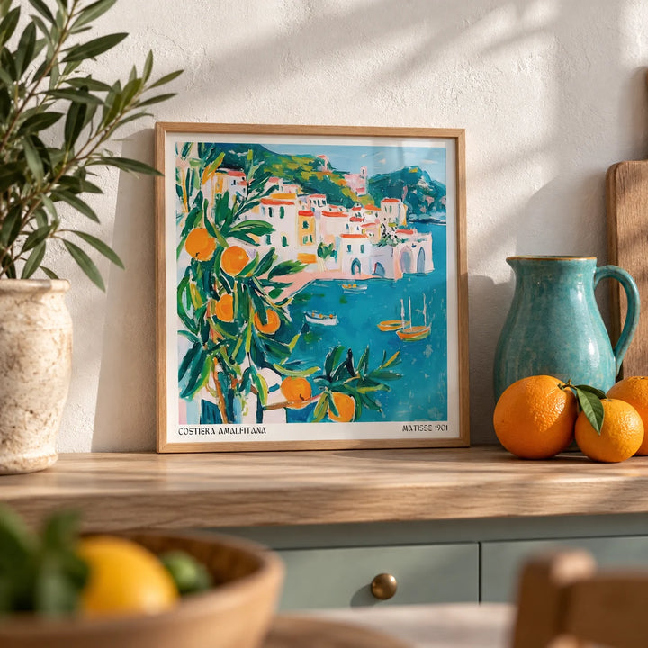 Amalfi Coast Print, a small A4 framed print leaning on a pale oak kitchen shelf