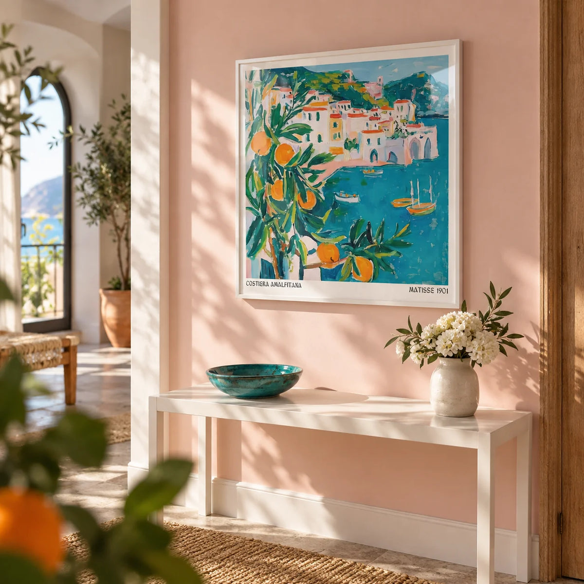 Amalfi Coast Print, framed on the wall of a sunny hallway with a soft blush pink wall