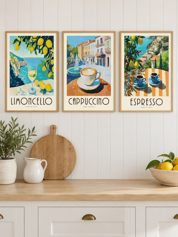 Amalfi Coast Prints Set of 3 hung at eye level above a wooden kitchen worktop: Amalfi Limoncello, Morning Piazza and Amalfi Espresso shown framed side by side (frames not included)