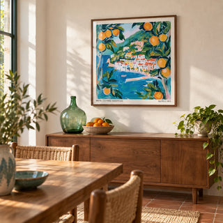 Amalfi Wall Art, framed on the wall of a bright dining room with a warm white plaster wall and a terracotta floor in plain tiles
