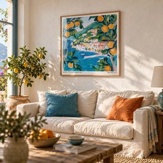 Amalfi Wall Art, framed on the wall of a relaxed Mediterranean living room with a limewashed white wall