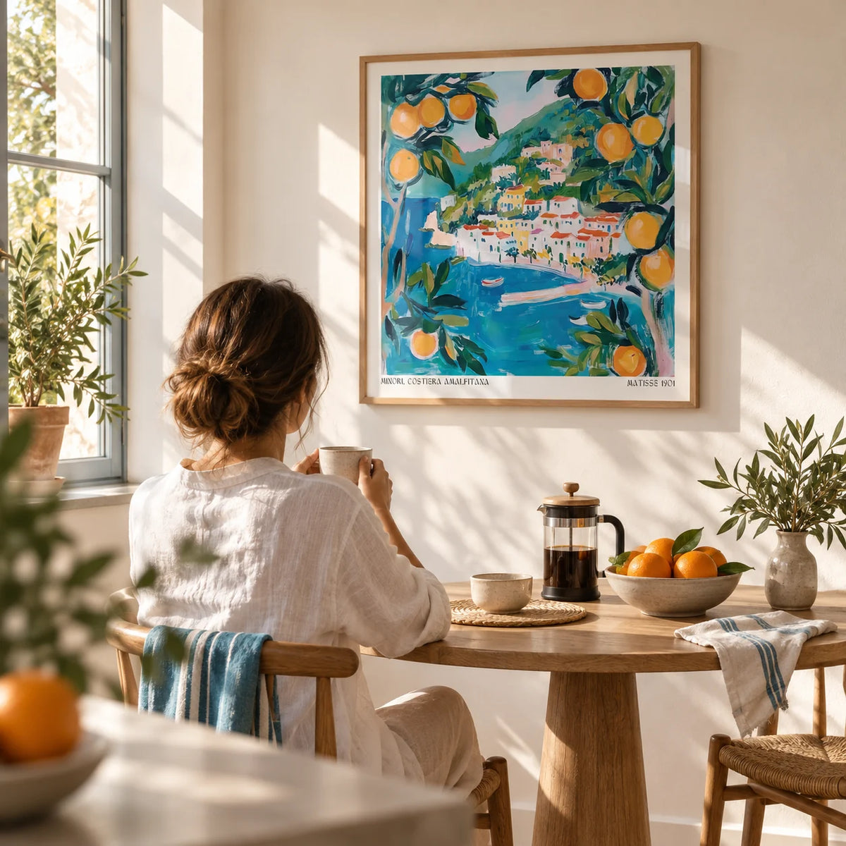 Amalfi Wall Art, framed on the wall of a sunny breakfast nook with a warm white wall in a kitchen