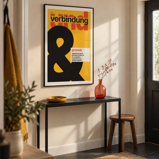 Ampersand Print, framed on the wall of a sharply styled entrance hallway in a UK first flat with a cream wall and charcoal floor