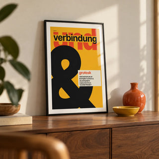 Ampersand Print, a small A4 framed print leaning on a walnut sideboard in a living room