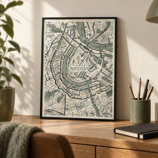 Amsterdam Map Art Print, a small A4 framed print leaning on an oak writing desk