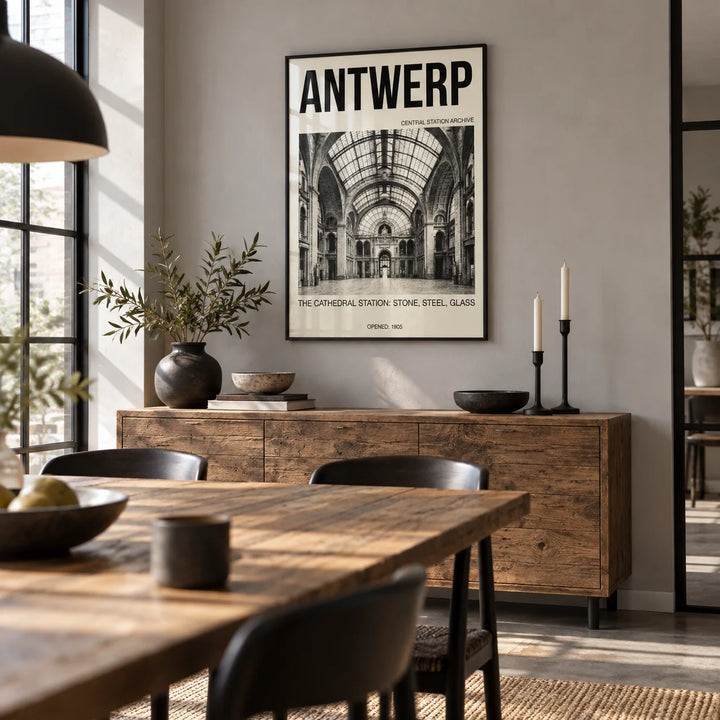 Antwerp Central Station Art Print, framed on the wall of a industrial-style dining room with a pale grey wall and black steel window frames