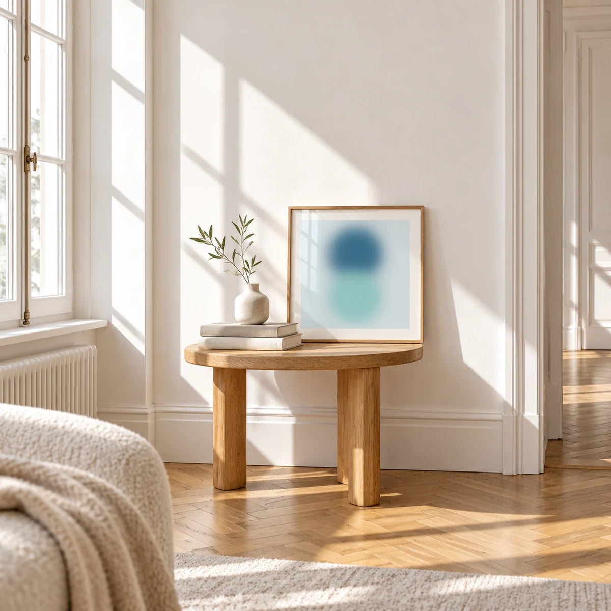 Aqua Print, a small square framed print leaning on a small solid oak side table